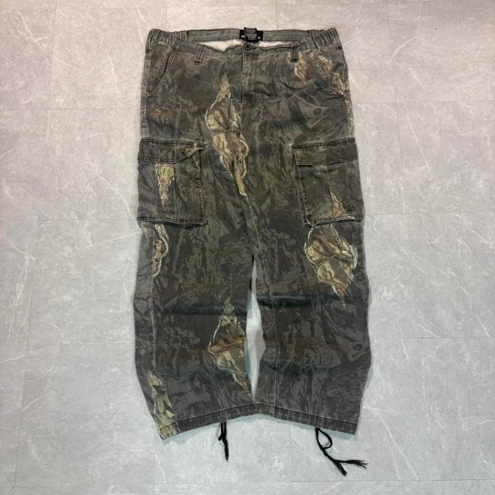 Camo cargo pants with a relaxed fit and a unique, worn look #grungevibes